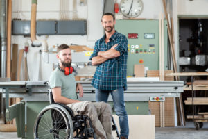 PA Employer in a workshop with his PA standing by machinery