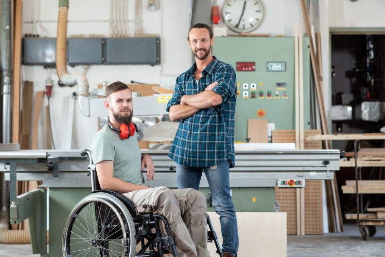 PA Employer in a workshop with his PA standing by machinery