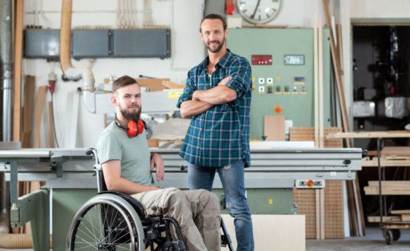 PA Employer in a workshop with his PA standing by machinery